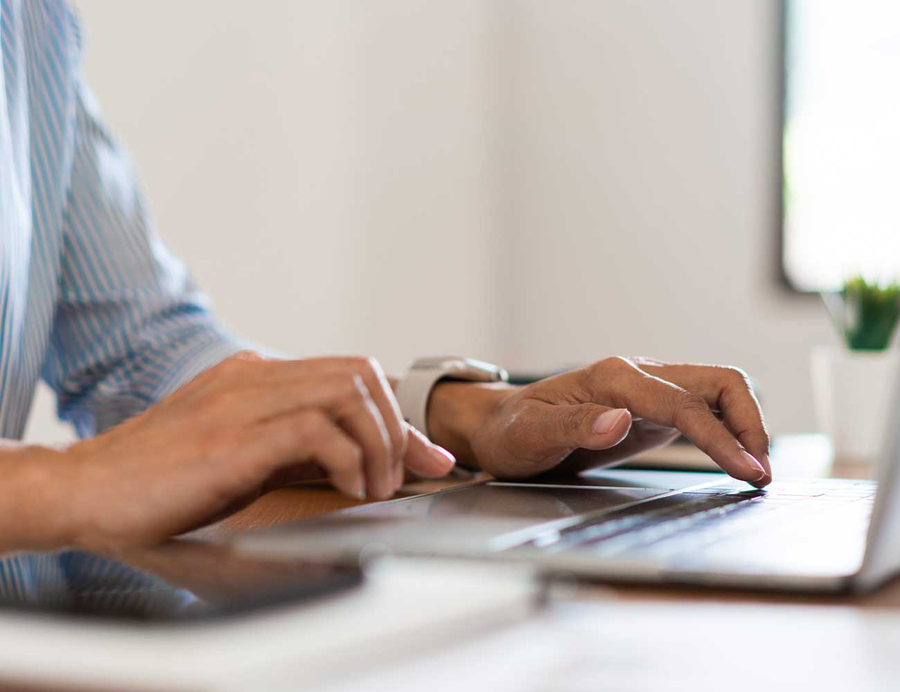 Person typing on a laptop.