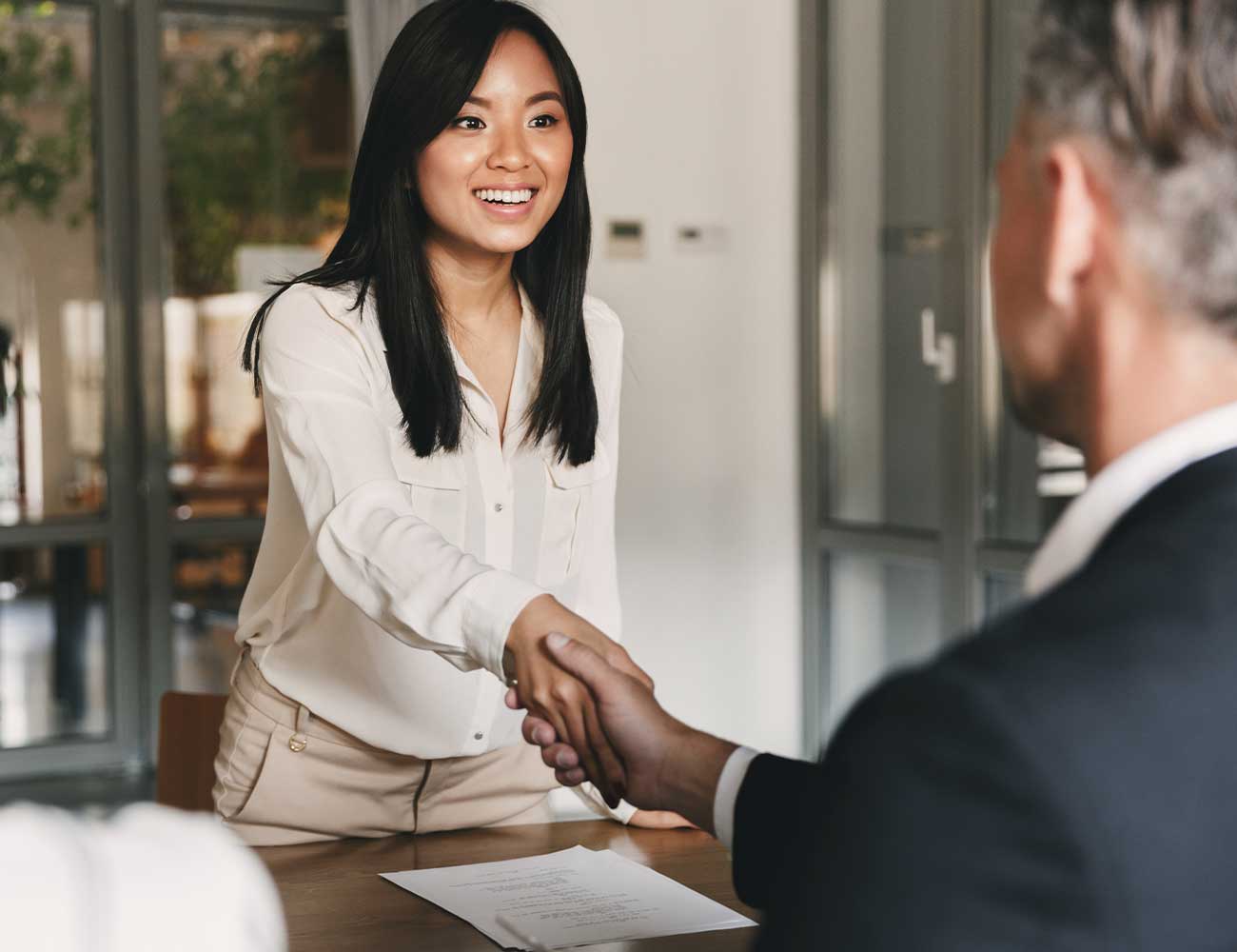 Woman shaking a man's hand.